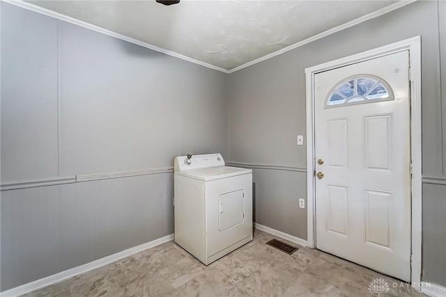 laundry area featuring washer / dryer, laundry area, crown molding, and baseboards