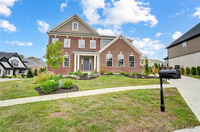 view of front of house featuring a front yard and brick siding