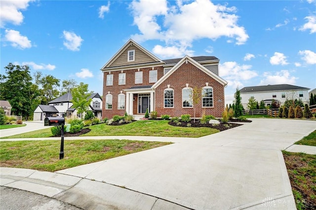 traditional home featuring brick siding, driveway, and a front lawn