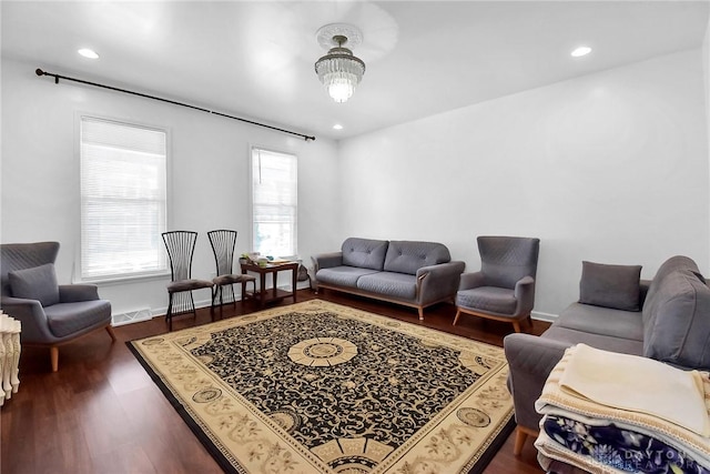 living area with visible vents, baseboards, dark wood-type flooring, and recessed lighting