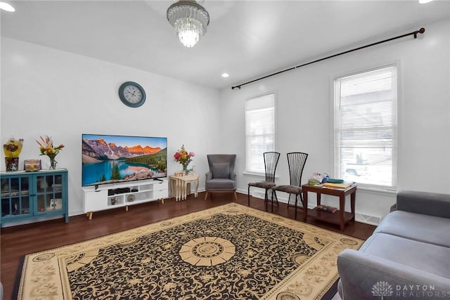 living room featuring wood finished floors, visible vents, and baseboards