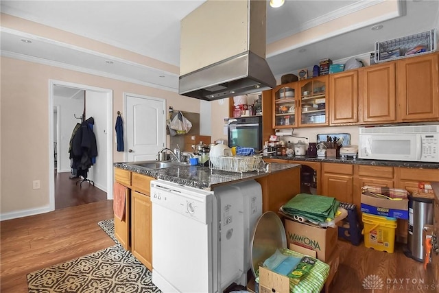 kitchen featuring white appliances, a sink, light wood-style floors, brown cabinets, and crown molding