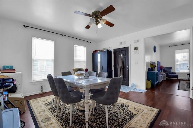 dining space with ceiling fan, baseboards, and wood finished floors