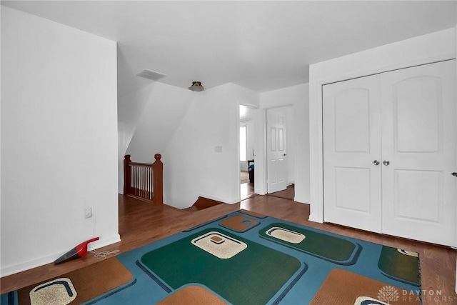 rec room with lofted ceiling, wood finished floors, and visible vents