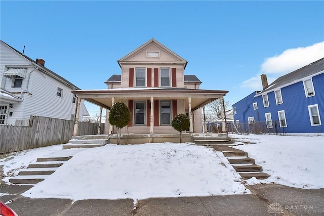 view of front of house featuring a porch and fence