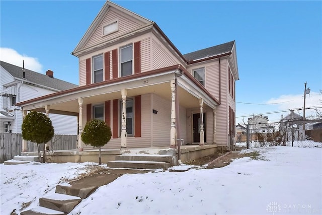 view of front of house with covered porch and fence