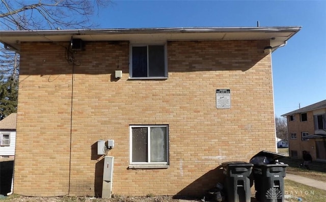 view of side of property with brick siding