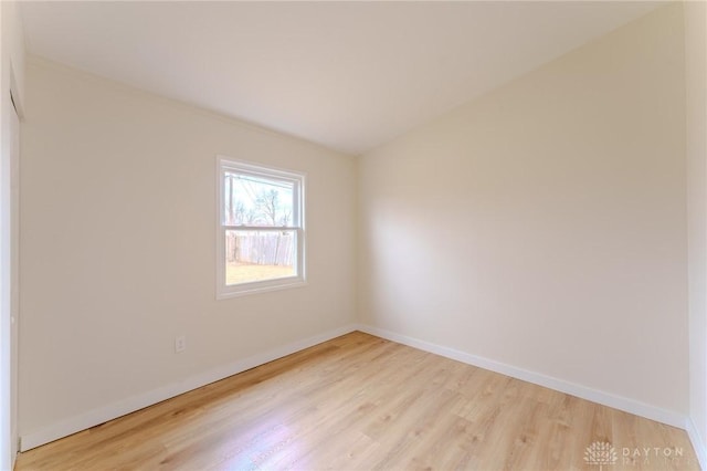 unfurnished room featuring light wood finished floors and baseboards