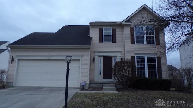 traditional-style home with a garage and concrete driveway