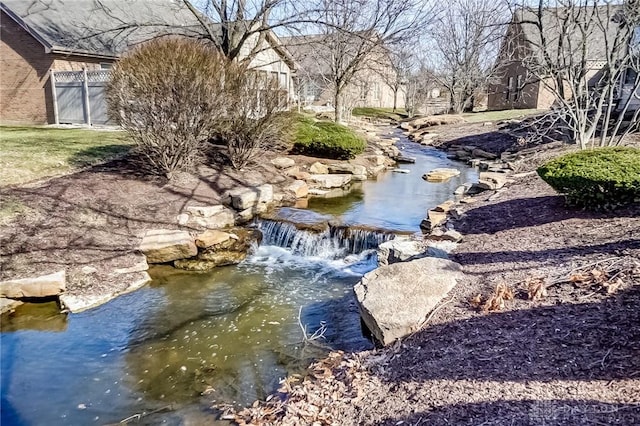 view of water feature with fence