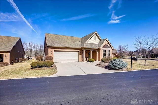 view of front of property with driveway, brick siding, and an attached garage