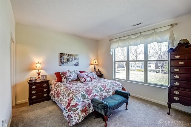 carpeted bedroom featuring visible vents and baseboards