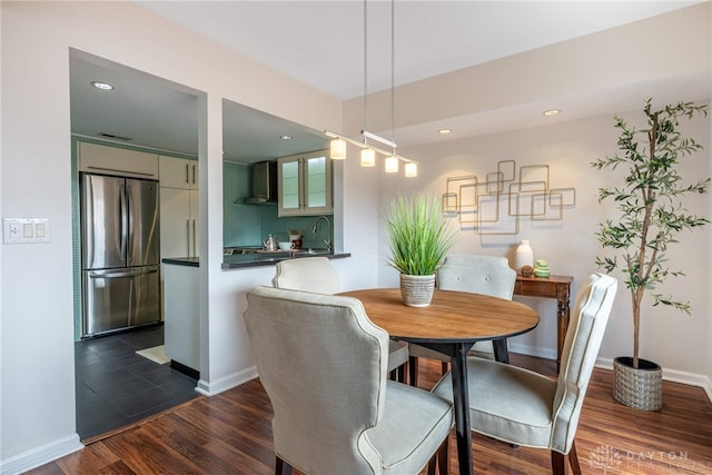 dining area with dark wood-style floors, baseboards, and recessed lighting