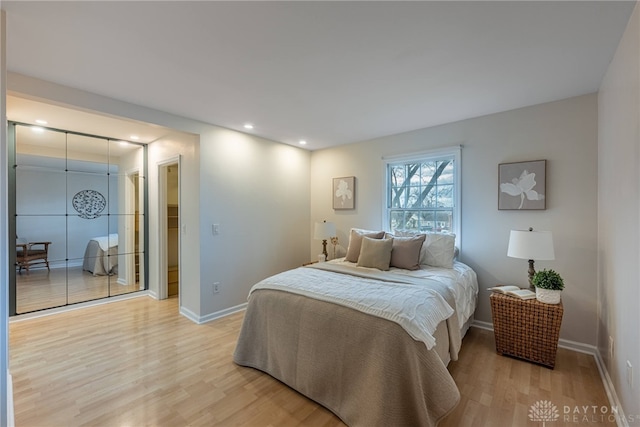 bedroom featuring light wood-style floors, baseboards, and recessed lighting