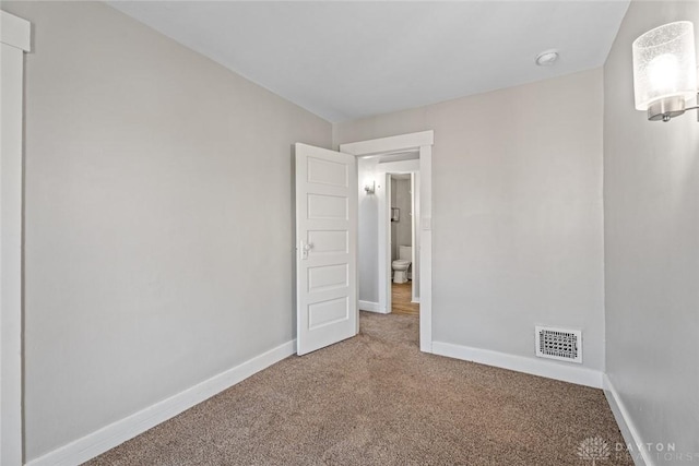 unfurnished bedroom featuring baseboards, visible vents, and carpet flooring