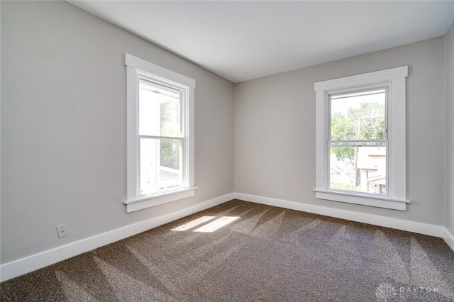 spare room with carpet flooring and baseboards