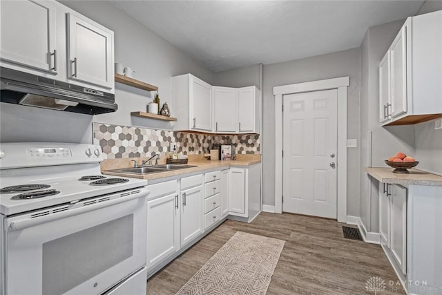 kitchen with white range with electric cooktop, white cabinets, under cabinet range hood, open shelves, and a sink