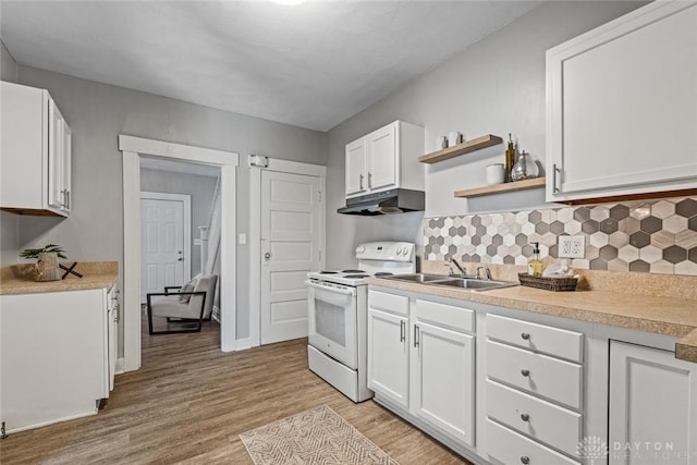 kitchen featuring under cabinet range hood, electric range, a sink, light wood-style floors, and white cabinets