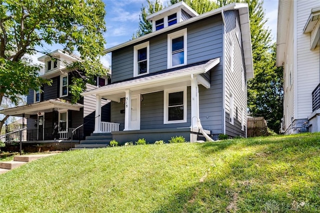 traditional style home with a porch and a front yard