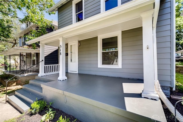 view of exterior entry with a porch