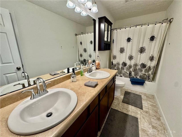 bathroom featuring baseboards, a sink, a textured ceiling, and toilet