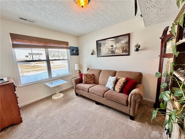 carpeted living room featuring a textured ceiling, visible vents, and baseboards