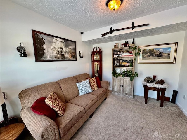 living room featuring carpet flooring, a textured ceiling, and baseboards