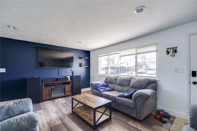 living area featuring baseboards and wood finished floors