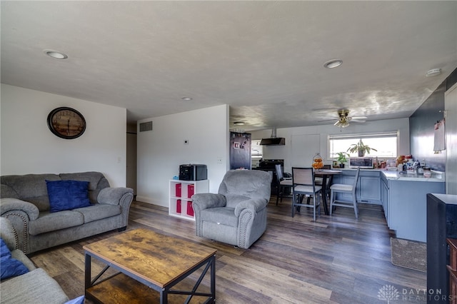 living area with a ceiling fan, recessed lighting, dark wood-style flooring, and visible vents