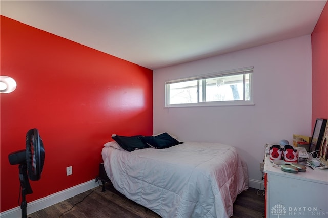 bedroom with baseboards and wood finished floors