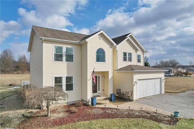 traditional-style house with a garage and driveway