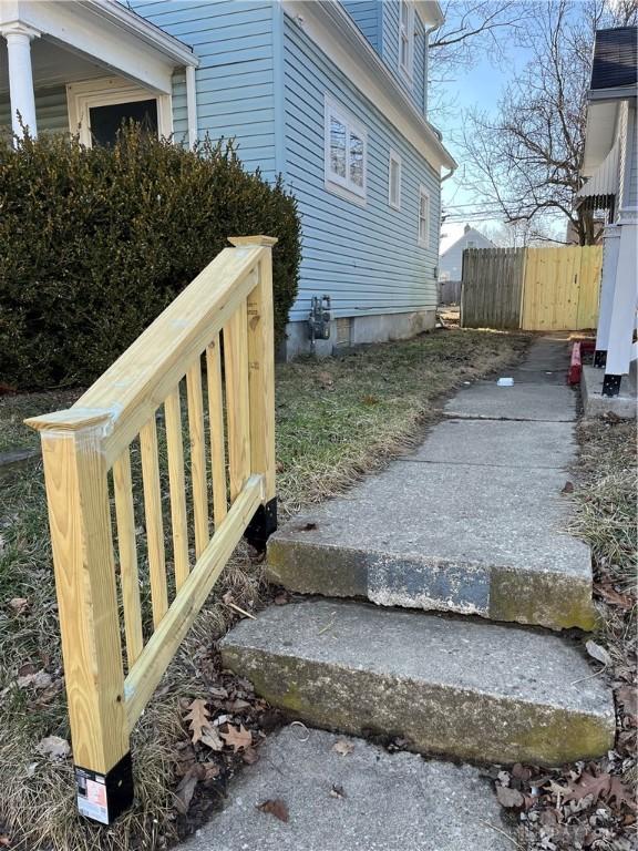 view of side of property featuring fence