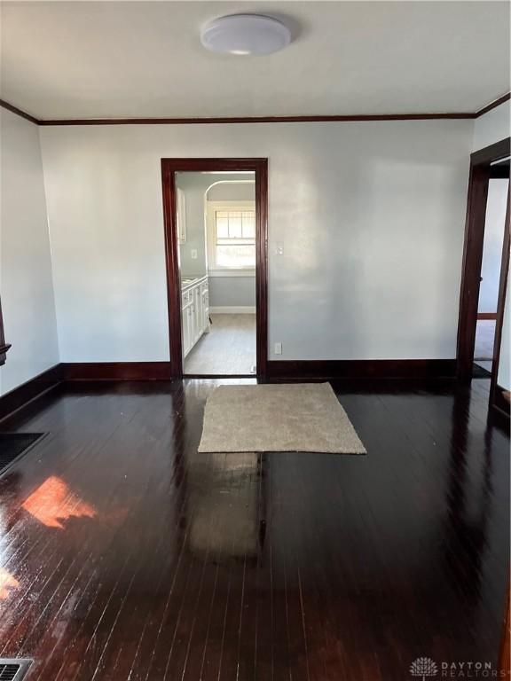 1205 Pursell Ave, Dayton, OH 45420 - unfurnished room featuring ornamental molding, visible vents, baseboards, and hardwood / wood-style flooring