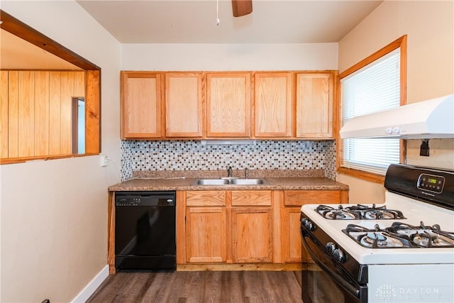 kitchen featuring dark wood-style flooring, a sink, black dishwasher, white gas range oven, and backsplash