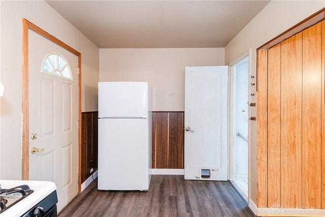 interior space featuring dark wood-style floors and a wainscoted wall