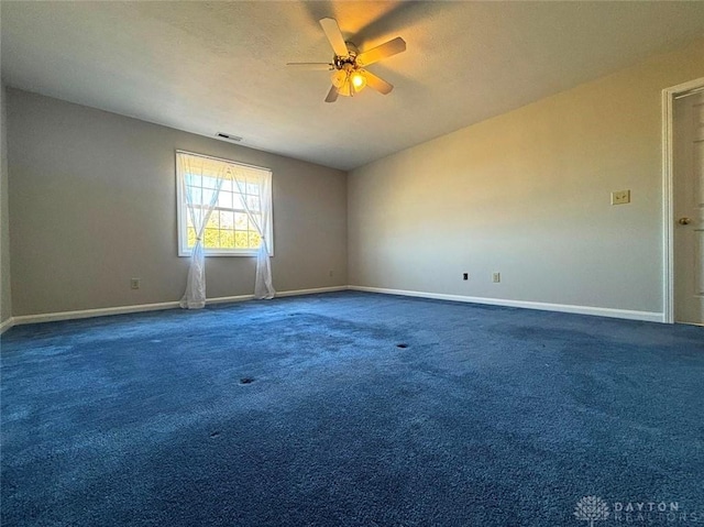 carpeted spare room with baseboards, visible vents, ceiling fan, and a textured ceiling