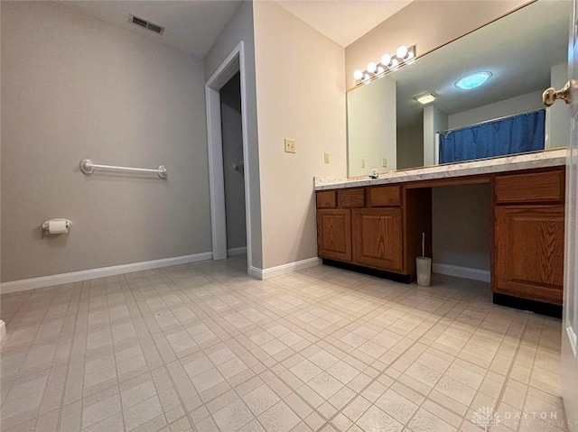 bathroom featuring baseboards, visible vents, and vanity