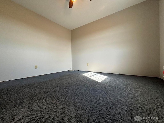 unfurnished room featuring carpet, vaulted ceiling, and ceiling fan