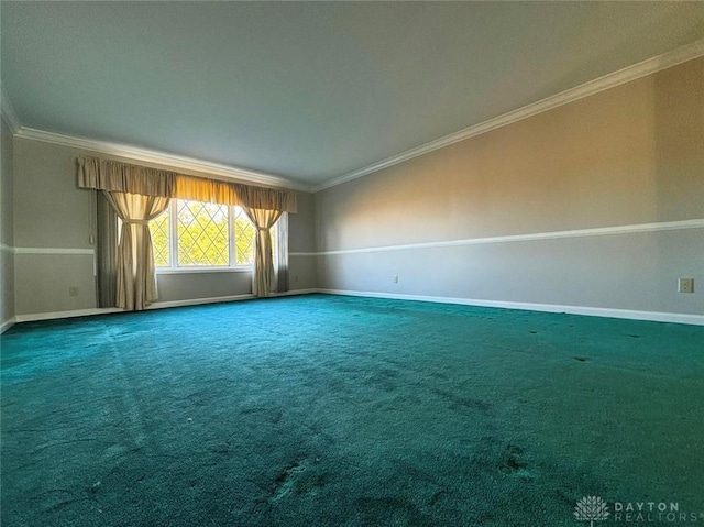 spare room with baseboards, carpet, and crown molding