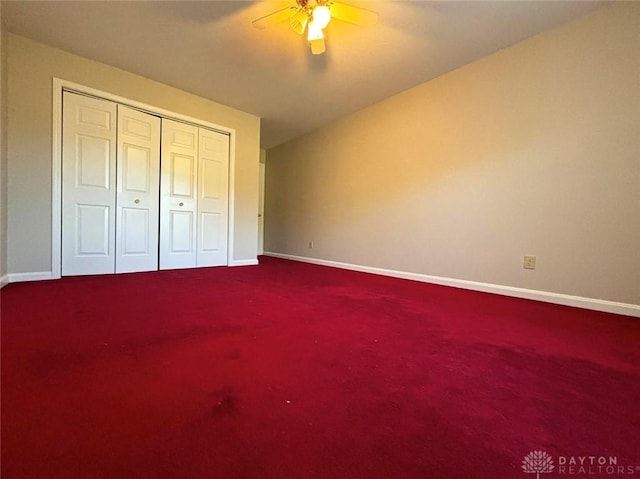 unfurnished bedroom with a closet, carpet flooring, and baseboards