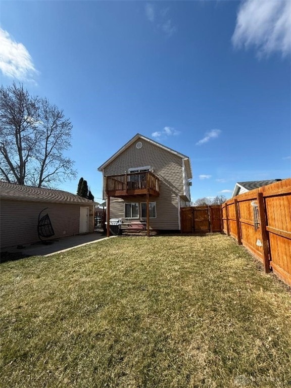 rear view of house with a lawn and fence private yard