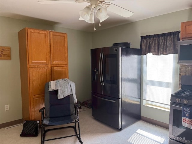 living area featuring visible vents, light colored carpet, baseboards, and a ceiling fan