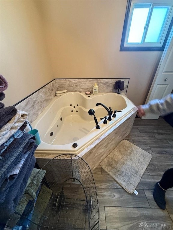 full bathroom featuring a tub with jets