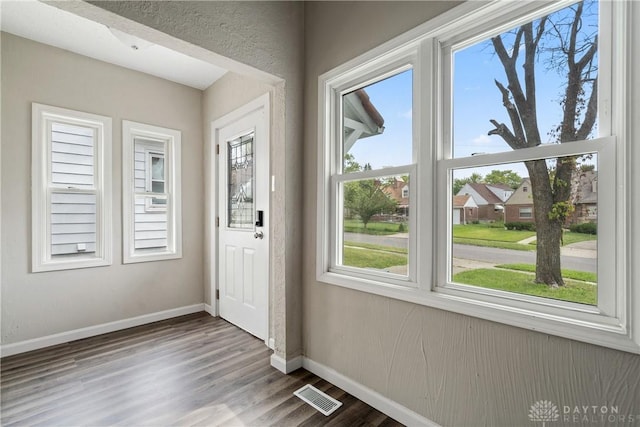 entryway featuring wood finished floors, visible vents, and baseboards