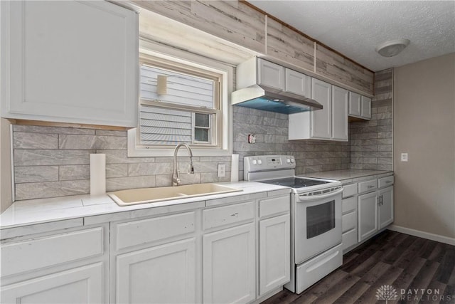 kitchen featuring a textured ceiling, dark wood-style flooring, a sink, light countertops, and white range with electric stovetop