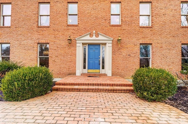 entrance to property with brick siding