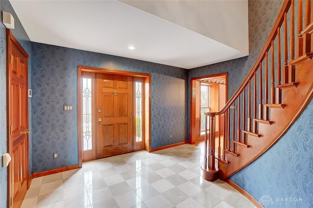 entryway featuring baseboards and wallpapered walls