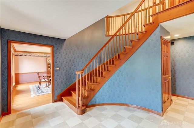 staircase featuring wallpapered walls, baseboards, and tile patterned floors