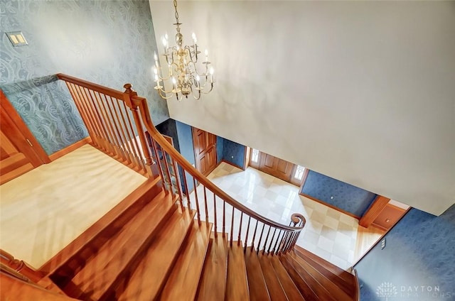 stairs featuring an inviting chandelier