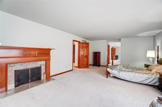 6485 Munger Rd, Dayton, OH 45459 - bedroom featuring visible vents, light carpet, baseboards, and a premium fireplace